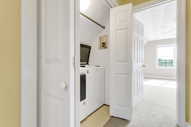 clothes washing area featuring light carpet and washer / clothes dryer