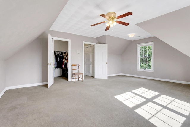 bonus room with ceiling fan, light colored carpet, and lofted ceiling