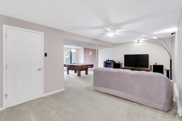 carpeted living room with ceiling fan, pool table, and brick wall