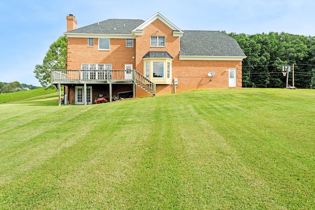 back of house featuring a deck and a lawn