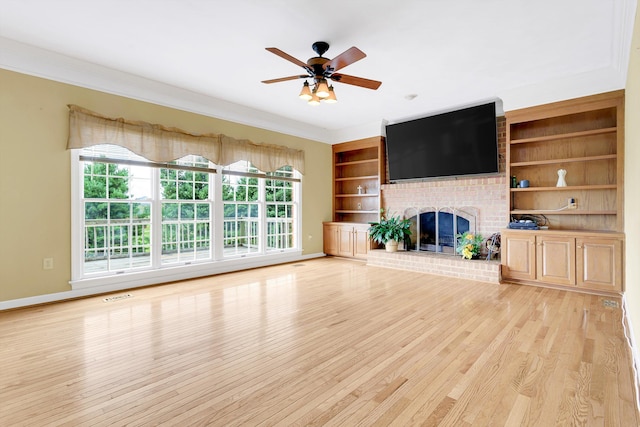 unfurnished living room featuring light hardwood / wood-style floors, ornamental molding, ceiling fan, and a brick fireplace