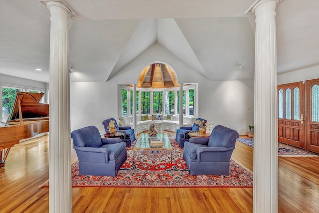 living room with ornate columns, plenty of natural light, and light hardwood / wood-style floors