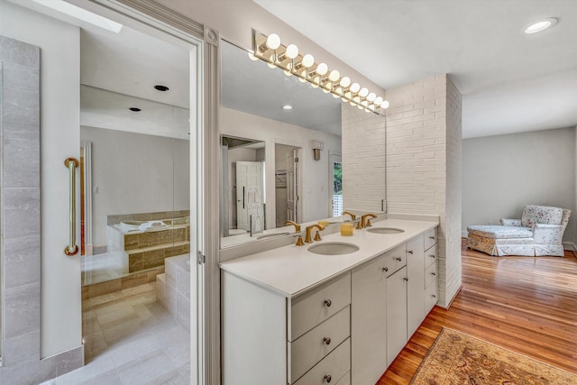 bathroom featuring a tub to relax in, vanity, and hardwood / wood-style flooring