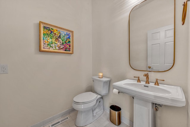 bathroom with tile patterned flooring and toilet