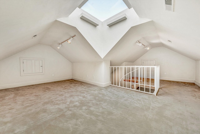 bonus room with lofted ceiling with skylight and light carpet