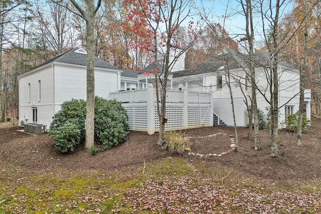 view of property exterior with a deck and central air condition unit