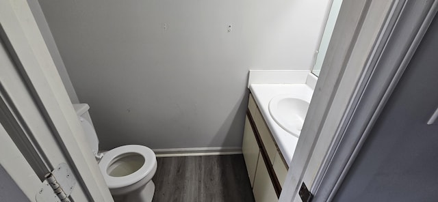 bathroom with vanity, hardwood / wood-style floors, and toilet