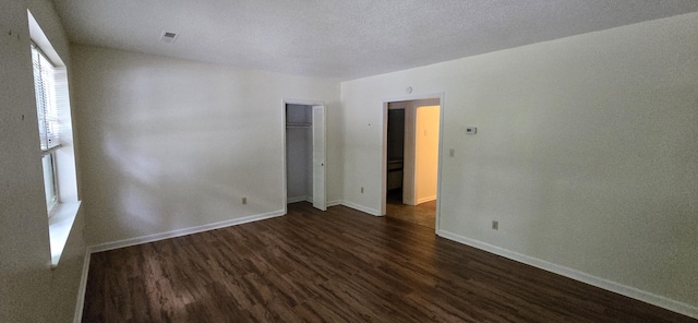 spare room featuring dark wood-type flooring