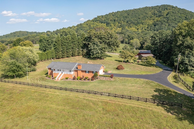 birds eye view of property featuring a forest view and a rural view