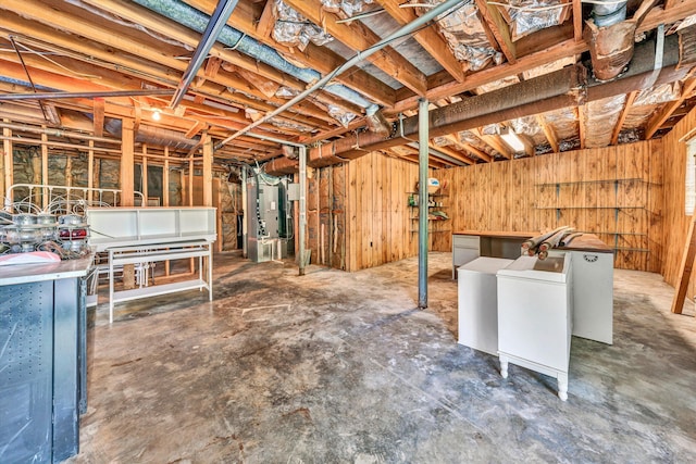 unfinished basement with washing machine and dryer and wood walls