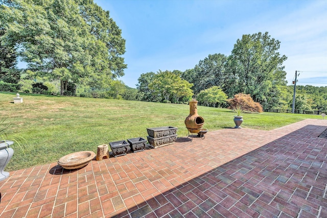 view of patio / terrace featuring an outdoor fire pit