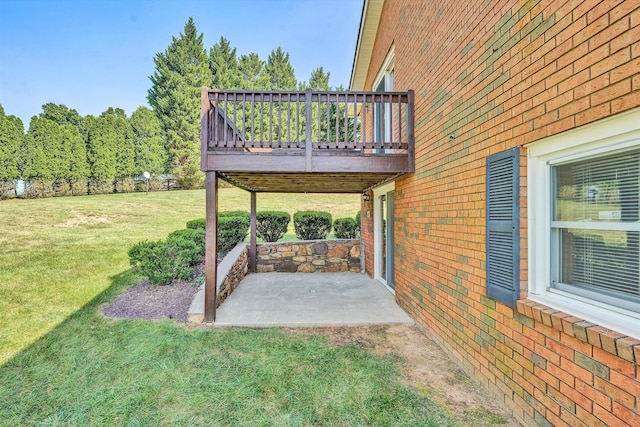 view of yard with a wooden deck and a patio