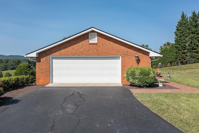 view of property exterior with a garage, a yard, and brick siding