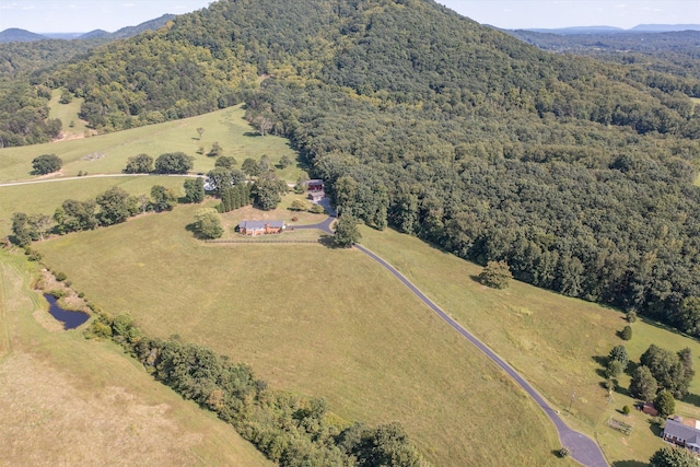 birds eye view of property with a forest view and a mountain view