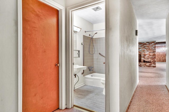 bathroom with tiled shower / bath and toilet