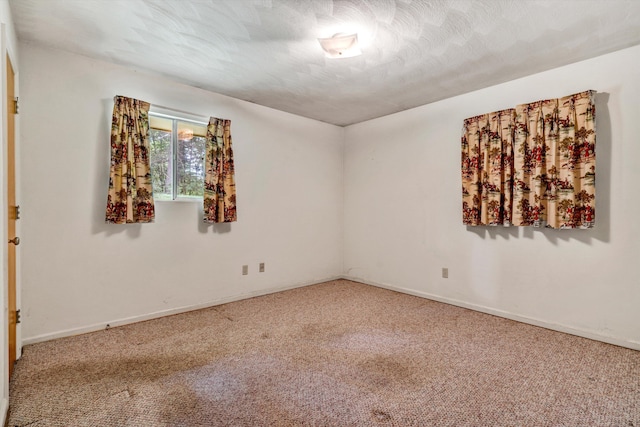 unfurnished room featuring carpet floors and a textured ceiling