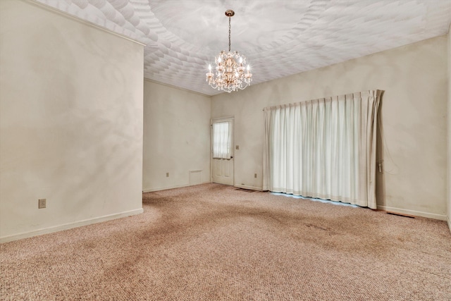 carpeted spare room with a notable chandelier