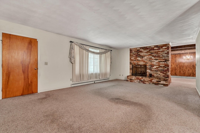 unfurnished living room featuring brick wall, a baseboard radiator, carpet, and a brick fireplace