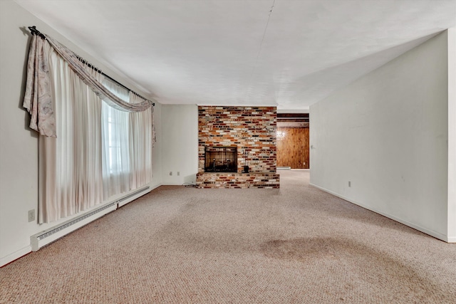 unfurnished living room with carpet, a brick fireplace, and a baseboard heating unit