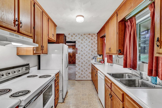 kitchen featuring white appliances and sink