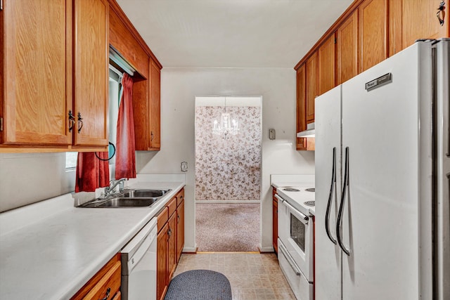 kitchen with sink, a chandelier, light carpet, pendant lighting, and white appliances