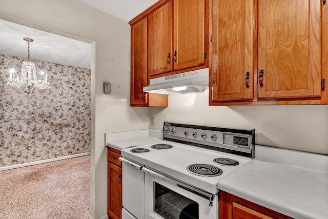 kitchen featuring pendant lighting, range with two ovens, and a notable chandelier