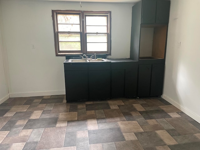 kitchen featuring sink and dark tile patterned floors