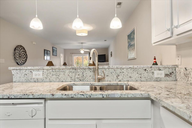 kitchen featuring white cabinetry, sink, light stone counters, white dishwasher, and decorative light fixtures