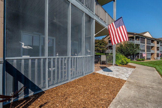 view of side of home featuring a sunroom