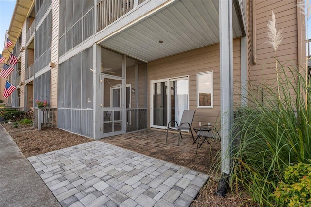 view of patio with a sunroom