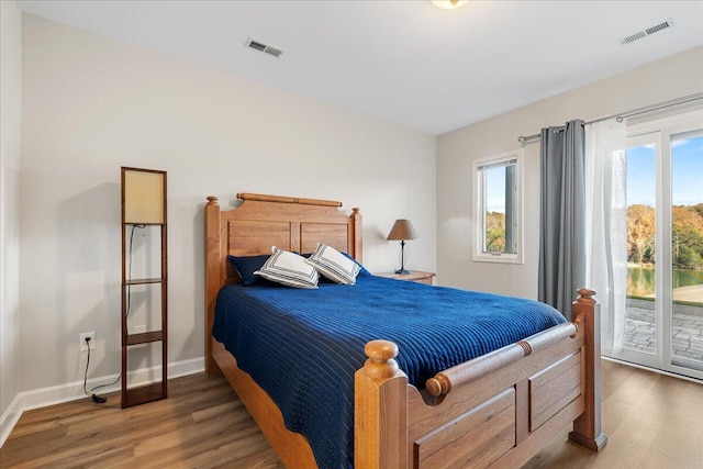 bedroom featuring hardwood / wood-style floors and access to outside