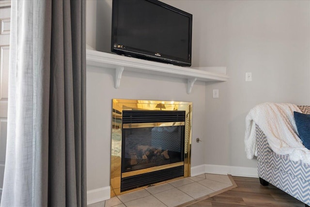 interior details with a tile fireplace and hardwood / wood-style floors