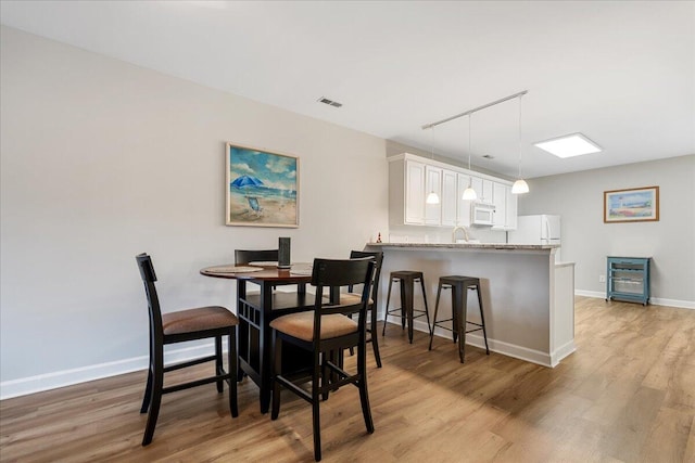 dining area featuring light wood-type flooring