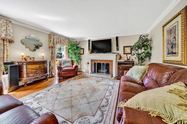 living room featuring a brick fireplace, crown molding, and hardwood / wood-style flooring