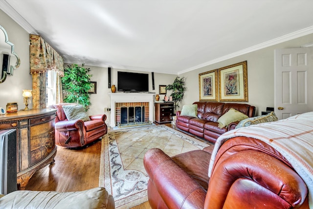 living room featuring a brick fireplace, crown molding, and hardwood / wood-style floors