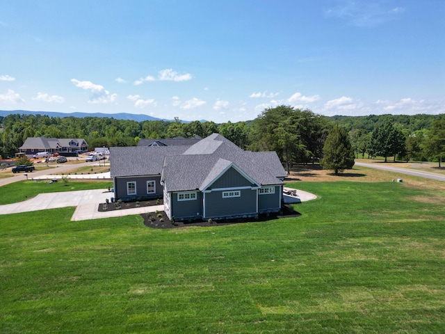 birds eye view of property with a mountain view and a wooded view