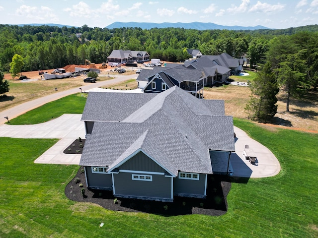 drone / aerial view with a mountain view and a wooded view