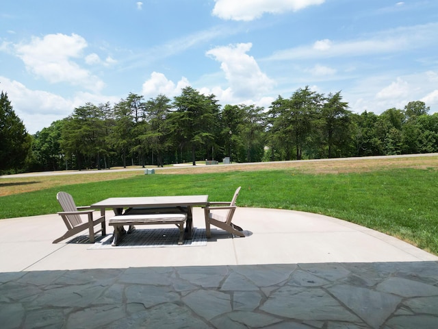 view of property's community featuring a yard and a patio area