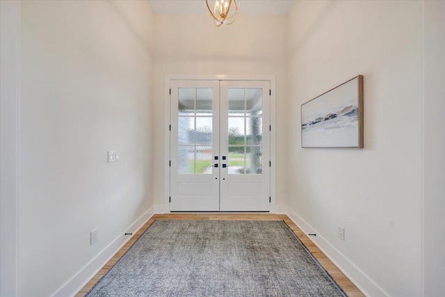 entrance foyer with light wood-type flooring, baseboards, and french doors