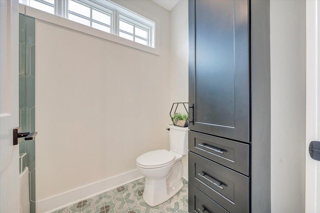 bathroom with tile patterned floors, toilet, and baseboards