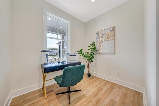 office with light wood-type flooring and baseboards