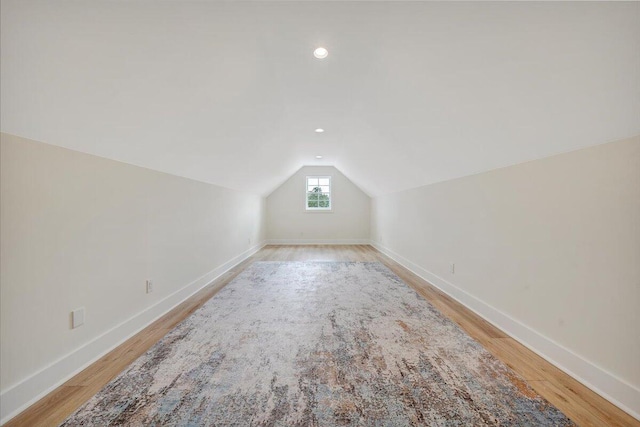 additional living space featuring vaulted ceiling, recessed lighting, light wood-style floors, and baseboards