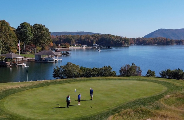 surrounding community featuring golf course view and a water and mountain view