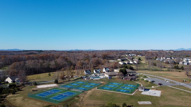 drone / aerial view featuring a view of trees and a mountain view