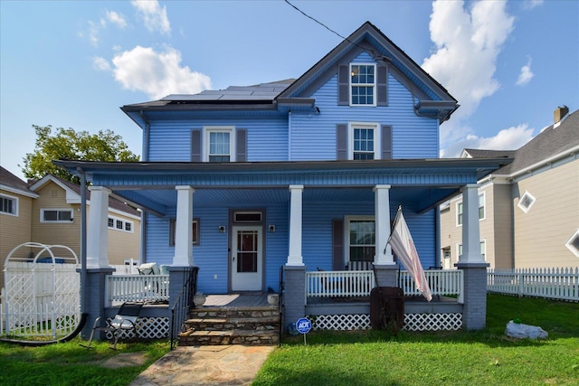 view of front facade with covered porch and a front yard