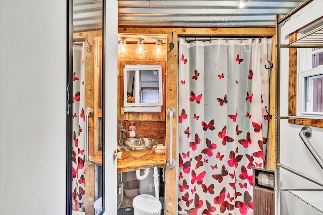 bathroom featuring sink and curtained shower