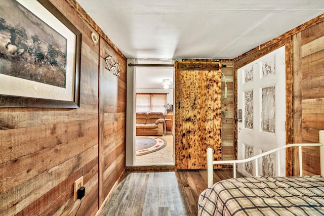 unfurnished bedroom with wood-type flooring and wooden walls