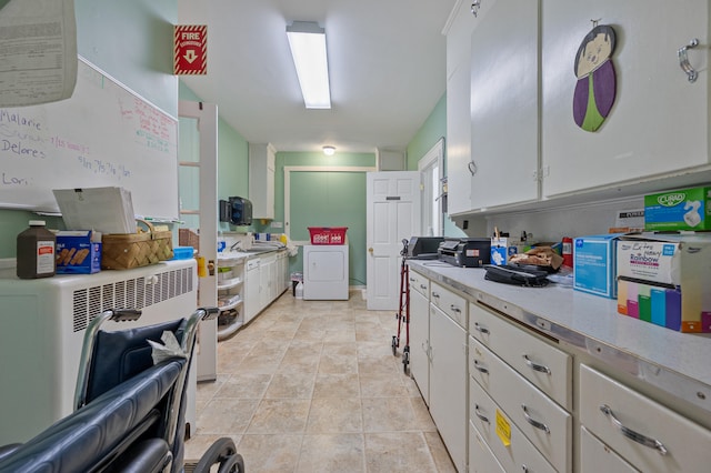 kitchen with light tile patterned flooring and white cabinets