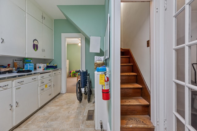 kitchen with white cabinets and light tile patterned floors