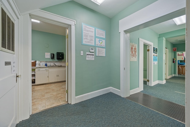 hallway featuring light carpet